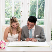 Couple signing register at Waltham Forest Register Office